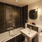Modern-bathroom-with-black-tiles-at-PREMIER-SUITES-Liverpool