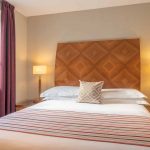 Large-double-bed-with-natural-light-and-modern-decor-at-PREMIER-SUITES-Birmingham