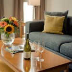 PREMIER-SUITES-Dublin-Sandyford-sofa-table-with-flowers-and-wine