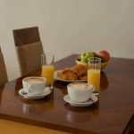 PREMIER-SUITES-Dublin-Sandyford-table-and-chairs-with-fruit-and-food-with-drinks
